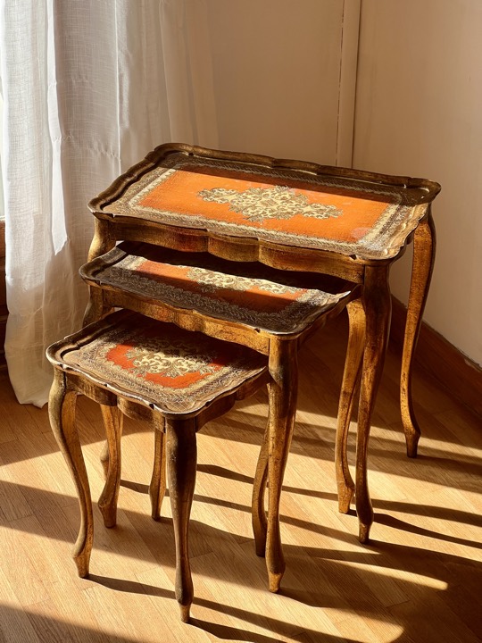 Nest of three Florentine giltwood tables in afternoon light